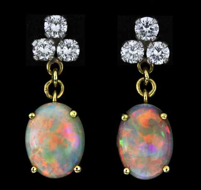 Appraisal: A pair of opal and diamond ear pendants set in