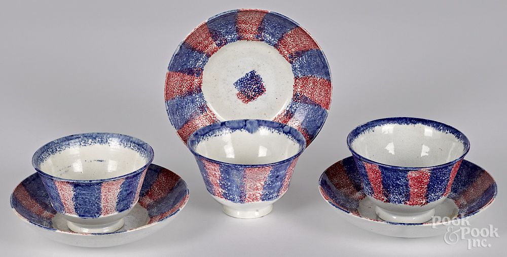 Appraisal: Red and blue rainbow spatter cups and saucers Three red