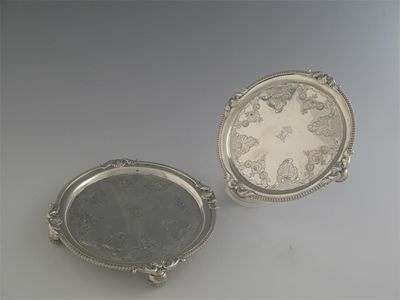 Appraisal: A pair of George III Irish circular waiters with part