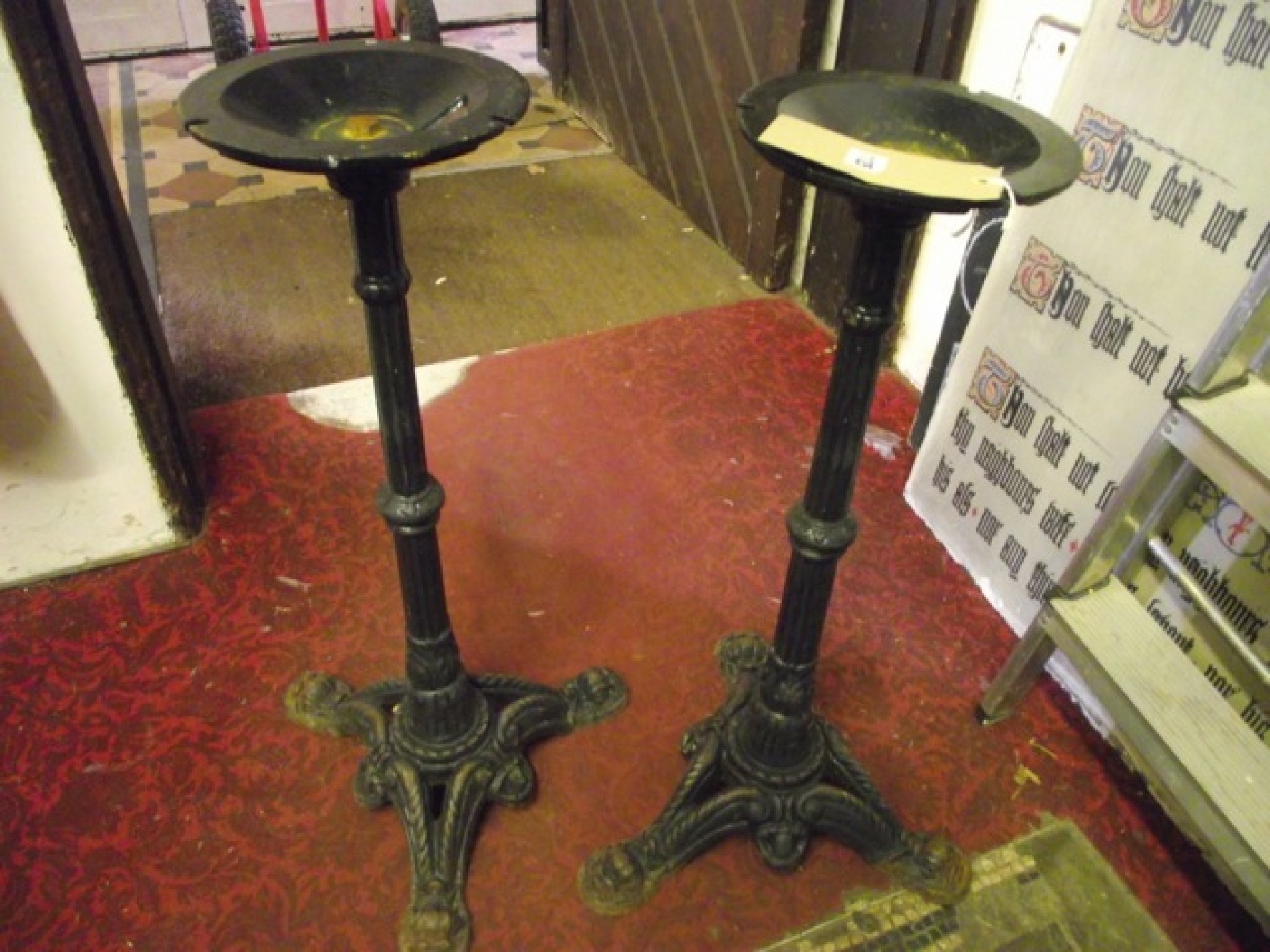 Appraisal: A pair of cast iron pub garden table bases with