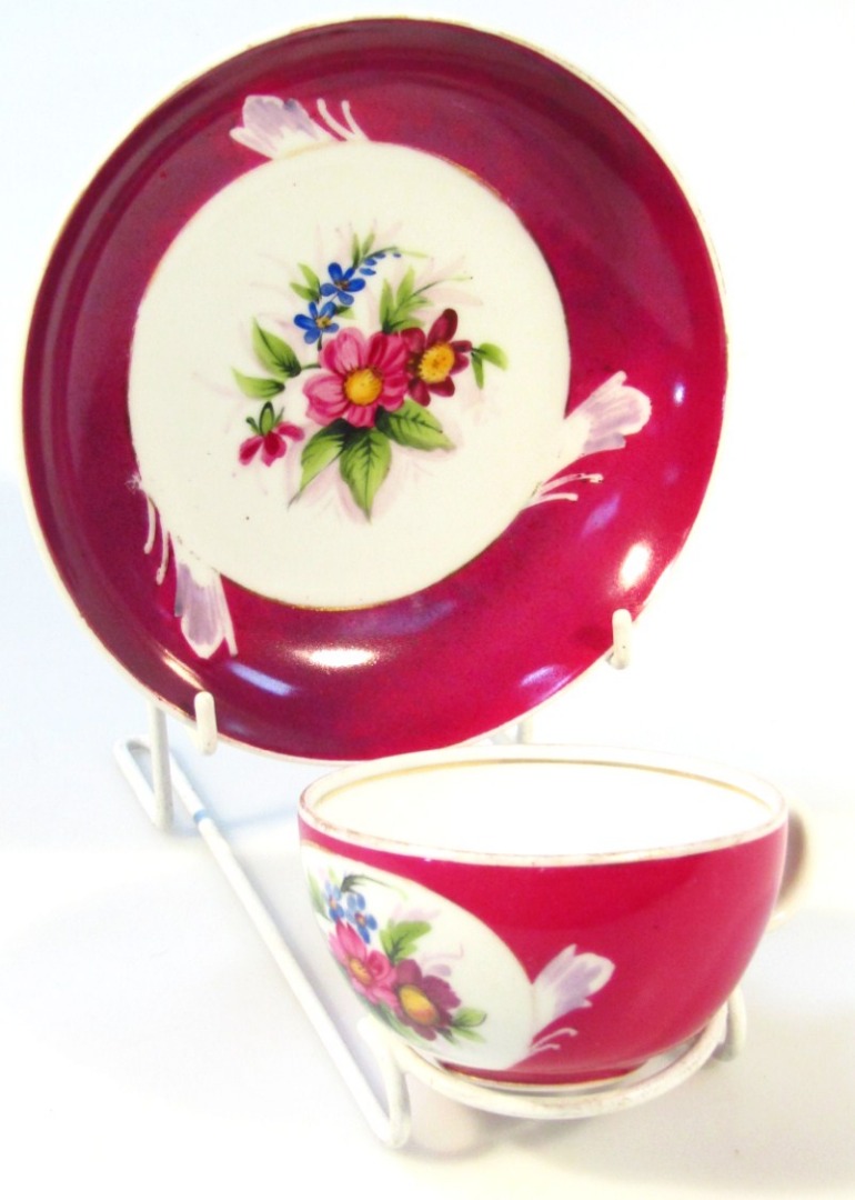 Appraisal: A Gardner Russian upholstered cup and saucer painted with flower