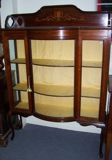 Appraisal: An Edwardian mahogany and inlaid bowfront display cabinet the arched