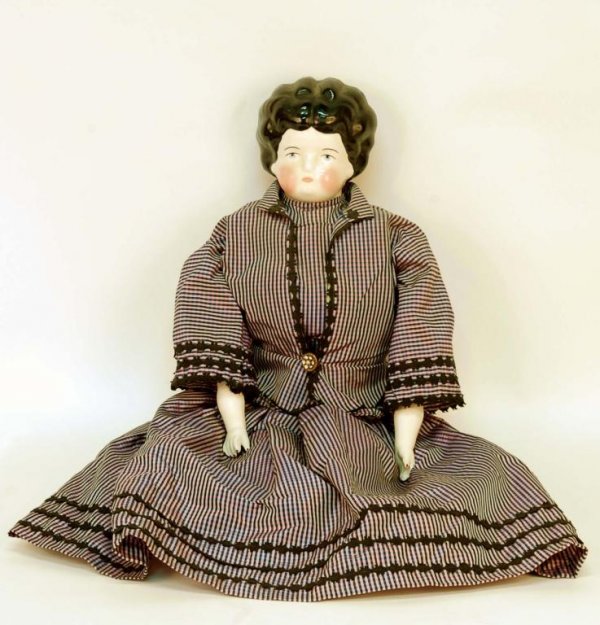 Appraisal: A china head doll Cloth body with china arms and