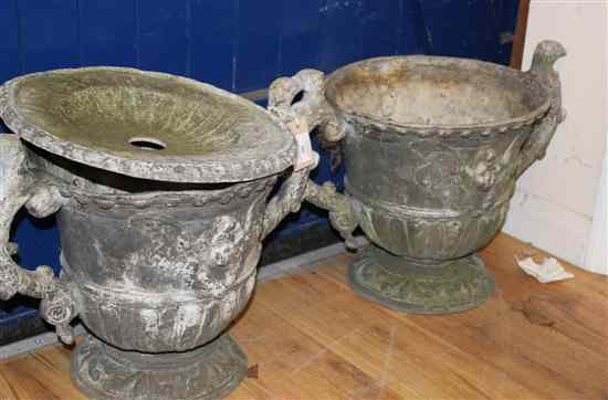 Appraisal: A pair of lead twin handled garden urns decorated with