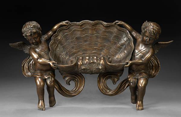 Appraisal: A Baroque style patinated bronze wall bracket The shell bowl