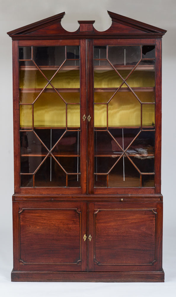 Appraisal: GEORGE III MAHOGANY BOOKCASE The arched pediment cresting above a