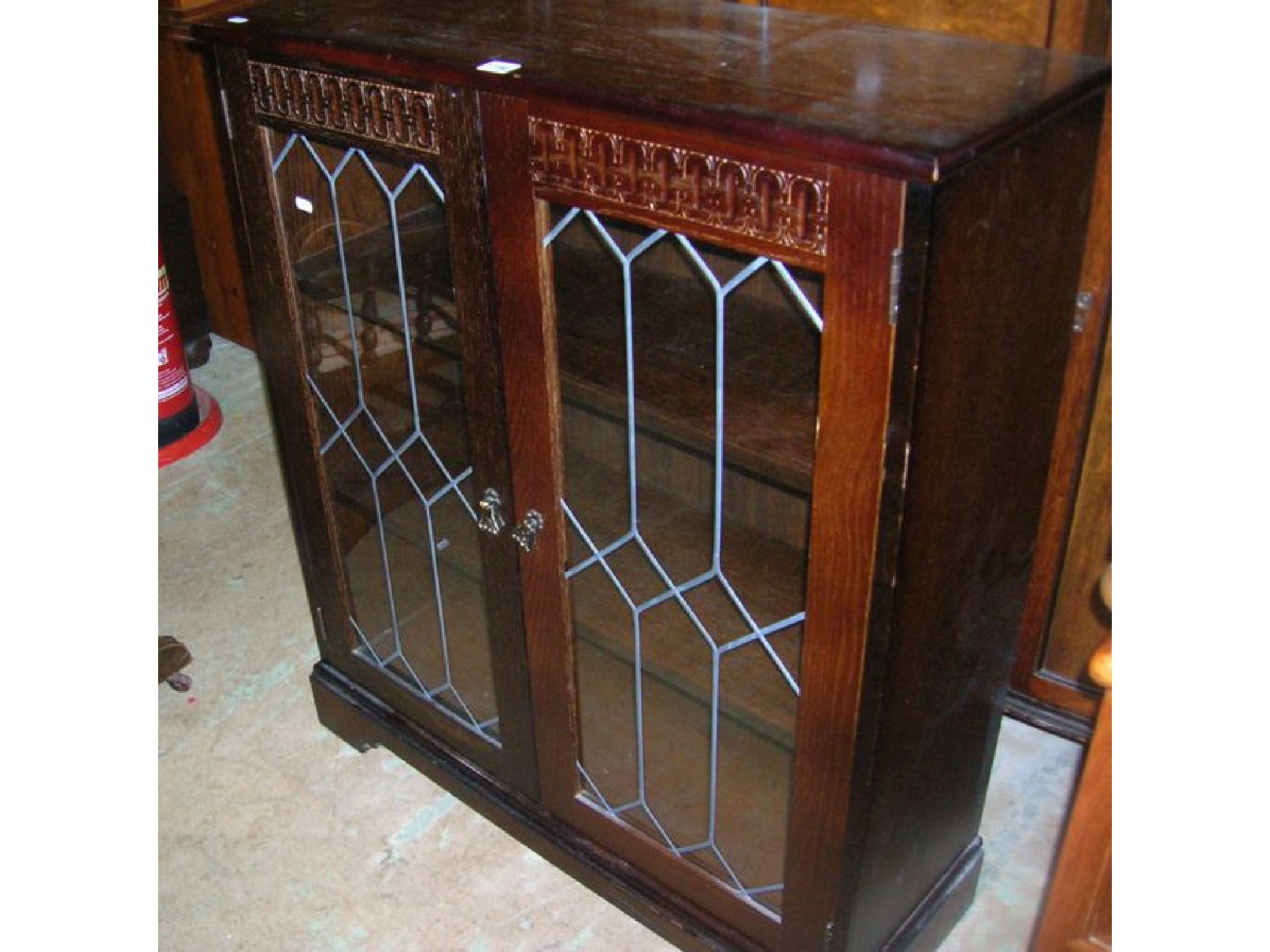 Appraisal: An Edwardian mahogany bow fronted side cupboard enclosed by three