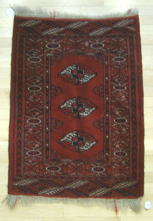 Appraisal: Bokhara mat ' x ' together with a braided throw