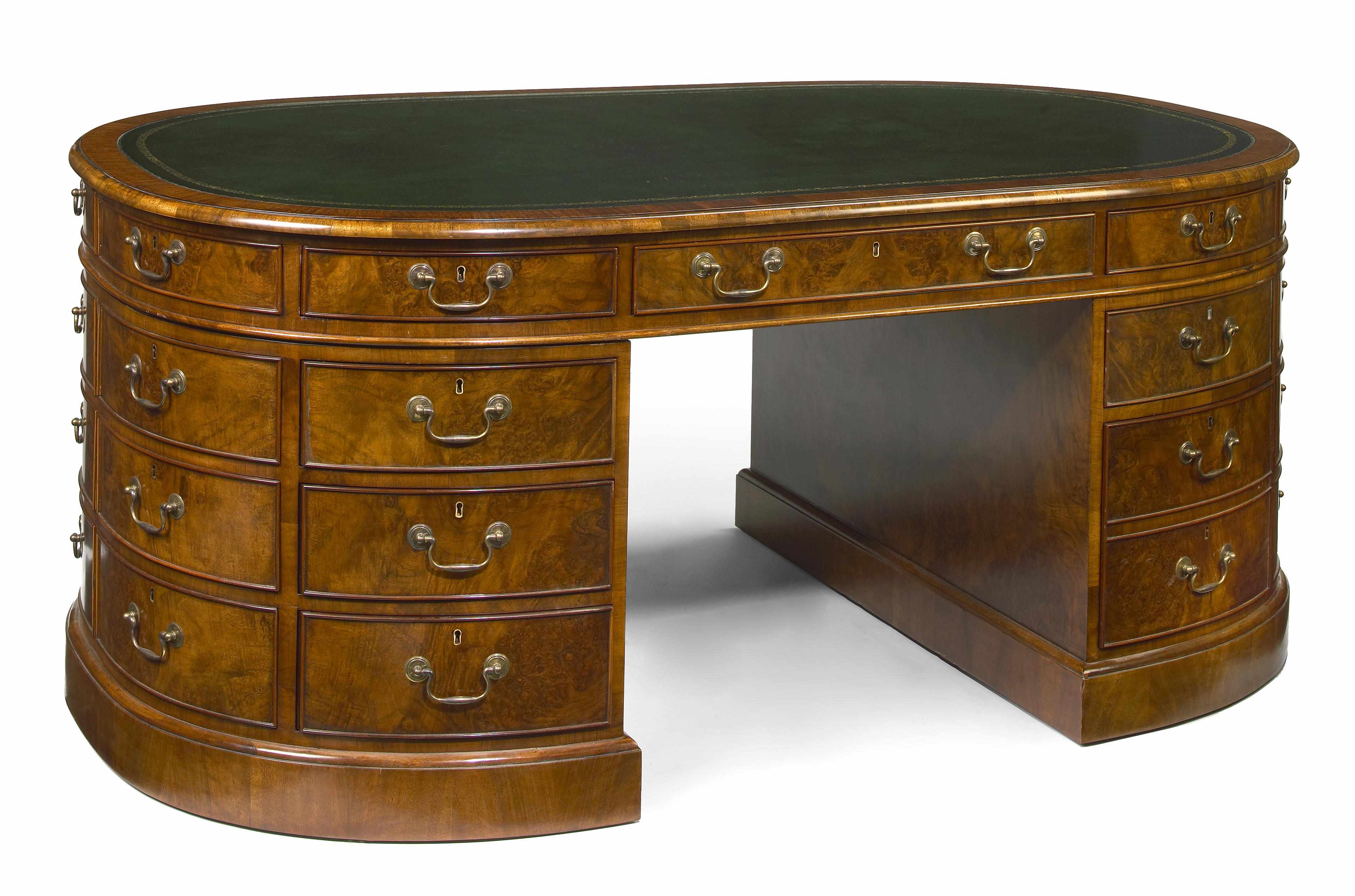 Appraisal: A George III style figured walnut oval partners' pedestal desk