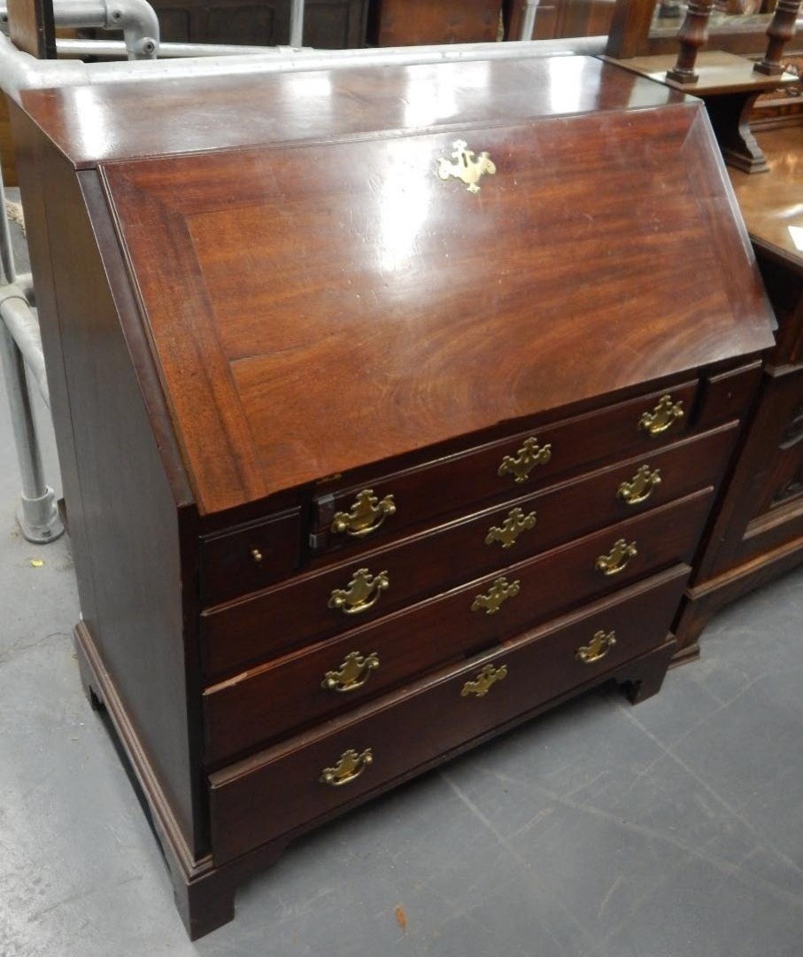 Appraisal: A George III mahogany bureau the fall enclosing a fitted