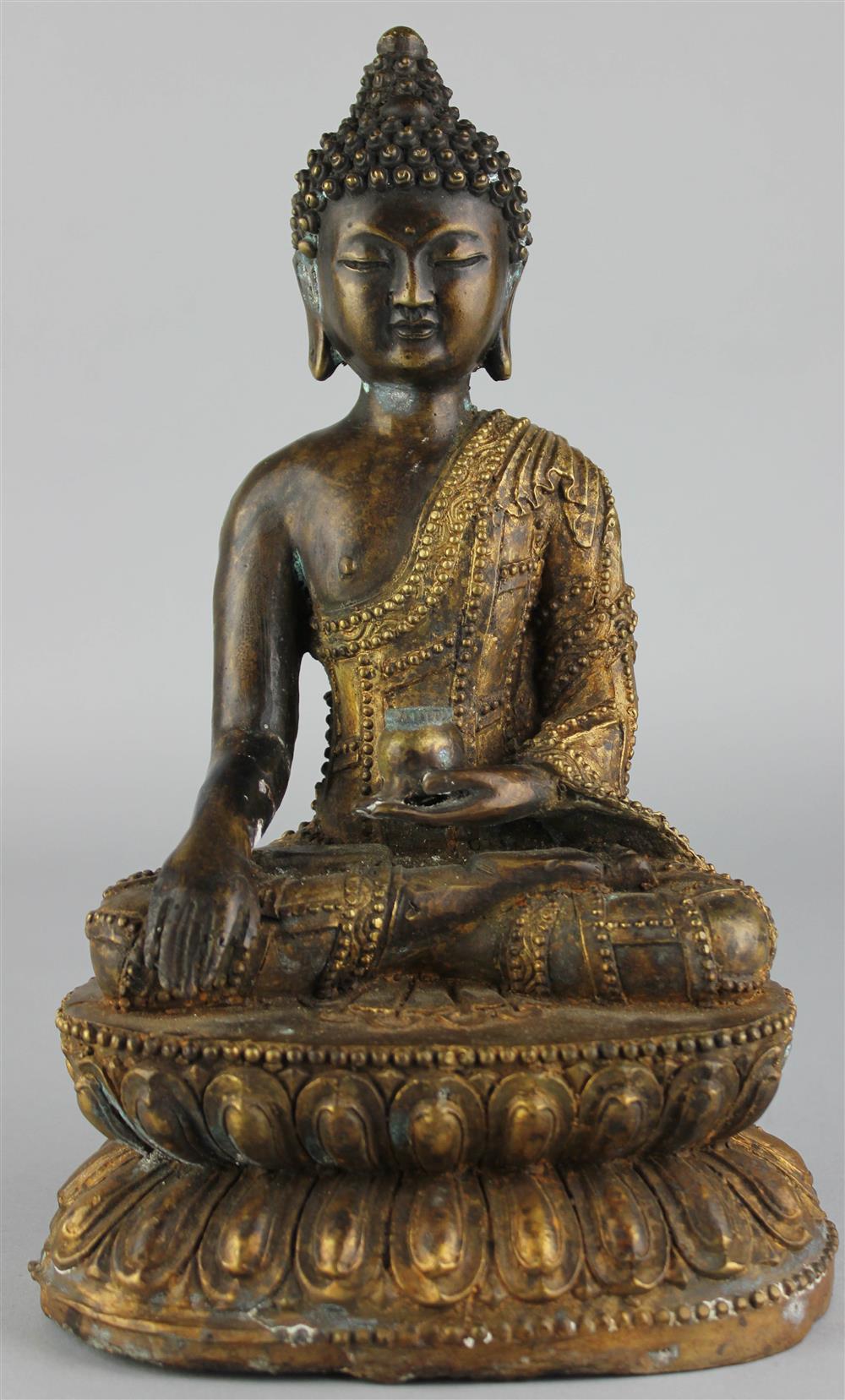 Appraisal: A SINO-TIBETAN PARCEL-GILT BRONZE SEATED BUDDHA dressed in an elaborately