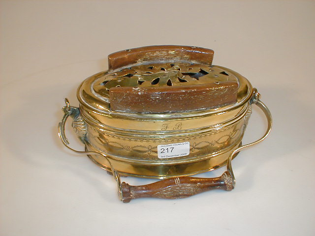 Appraisal: A thC brass oval carriage foot warmer with hinged pierced