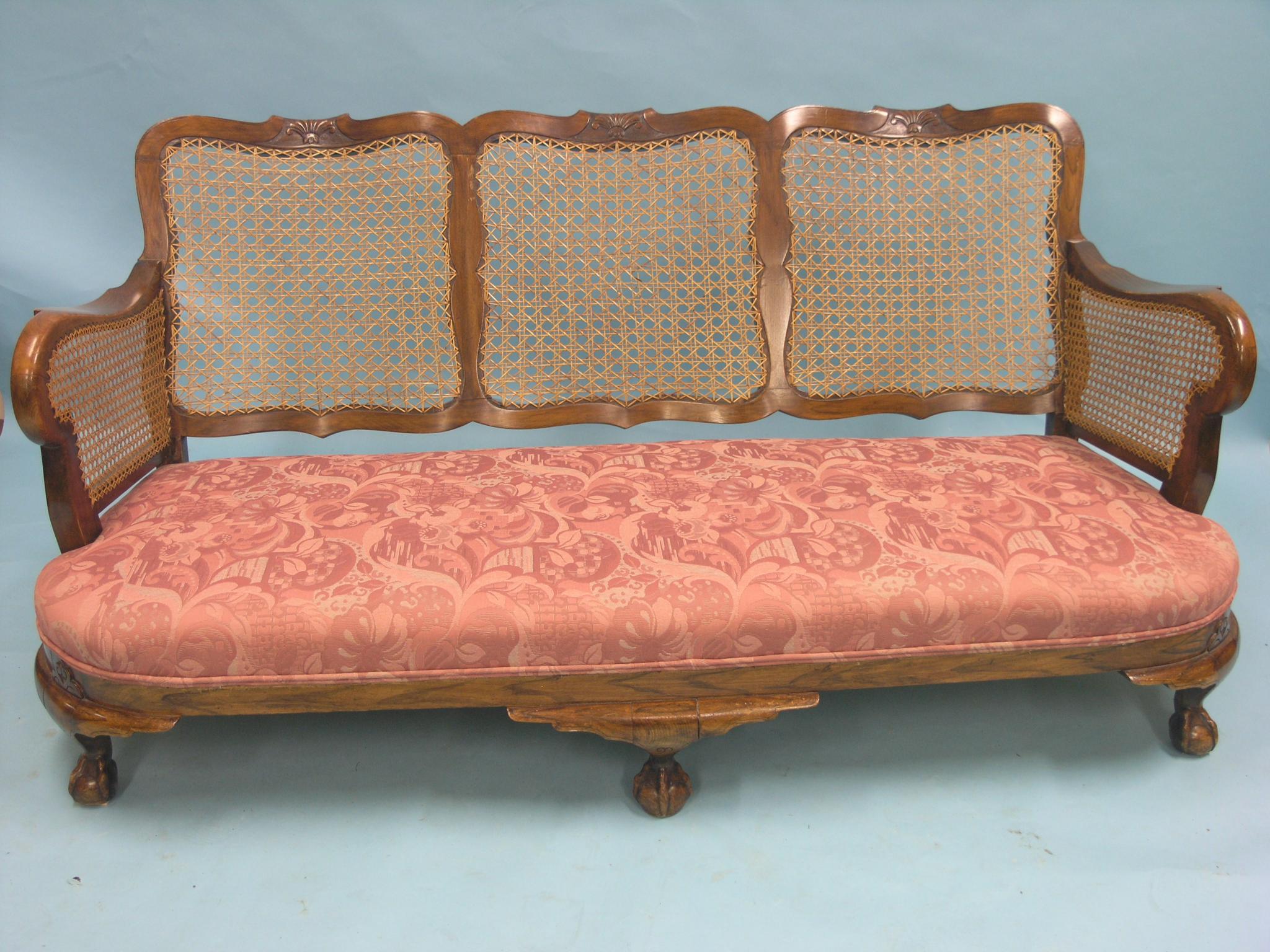 Appraisal: A grained walnut bergere suite three-seater settee and pair of