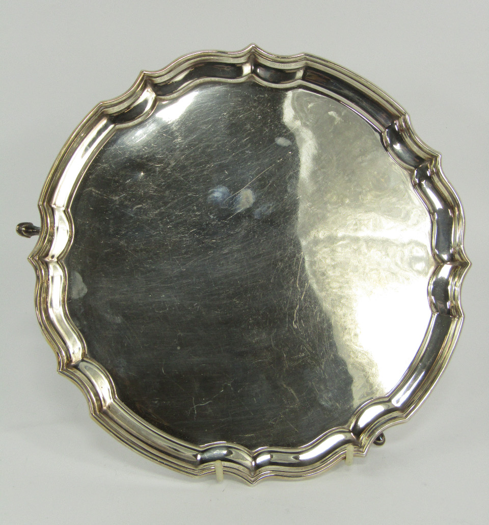 Appraisal: A silver circular pie crust salver raised on three hoof