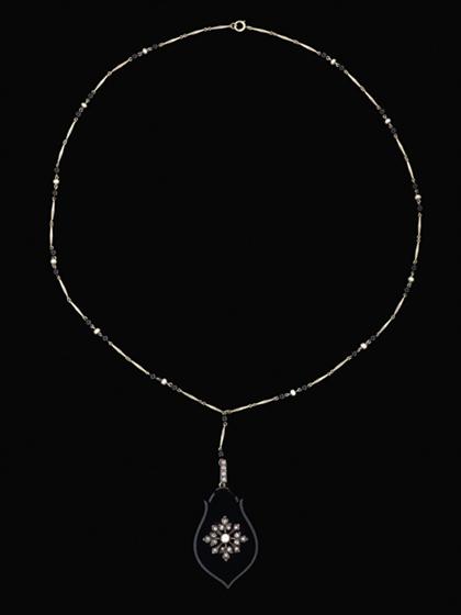 Appraisal: Onyx diamond and seed pearl pendant and neck chain Stylized