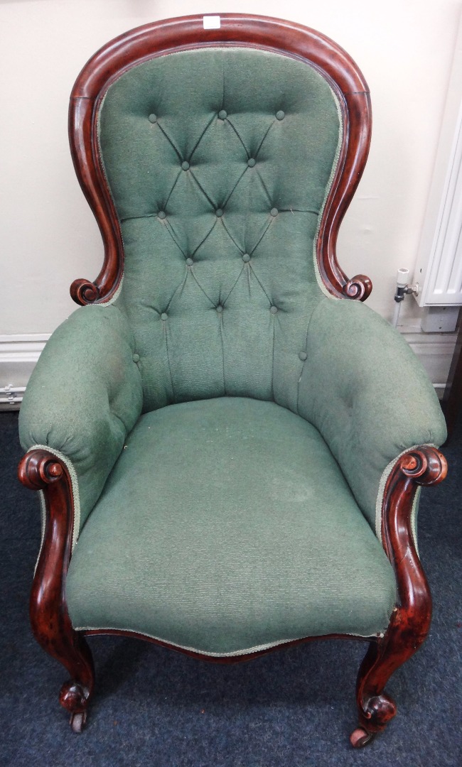 Appraisal: A Victorian mahogany spoon back armchair button down upholstered in