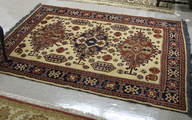 Appraisal: HAND KNOTTED ORIENTAL CARPET Persian tribal design of three geometric