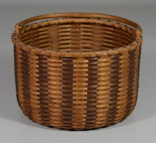 Appraisal: Brown and Natural Striped Swing Handle Basket diameter x h