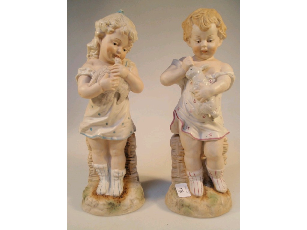 Appraisal: A pair of early thC German bisque figures modelled as