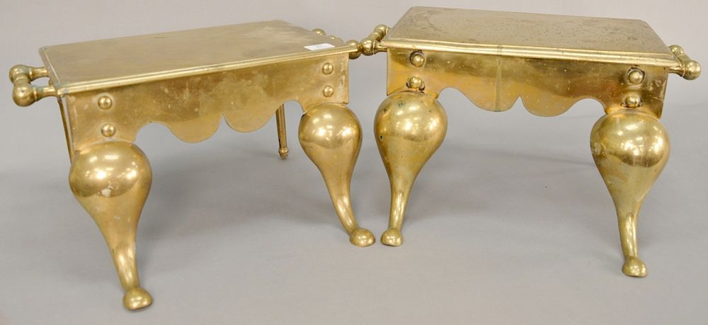 Appraisal: Two heavy brass footmen with two handles and downswept legs