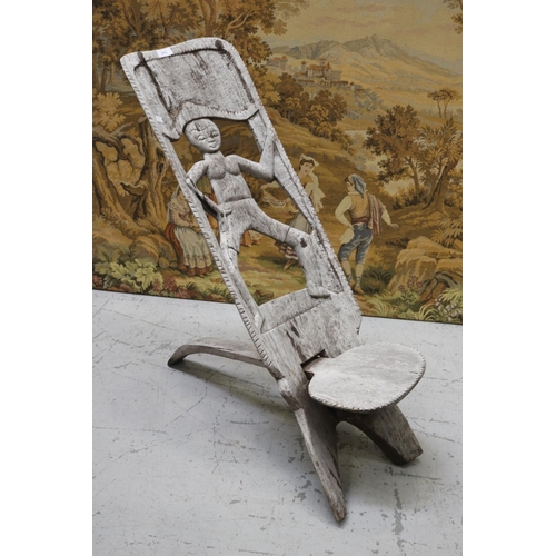 Appraisal: Primitive design folding wooden chair with carved figure to back