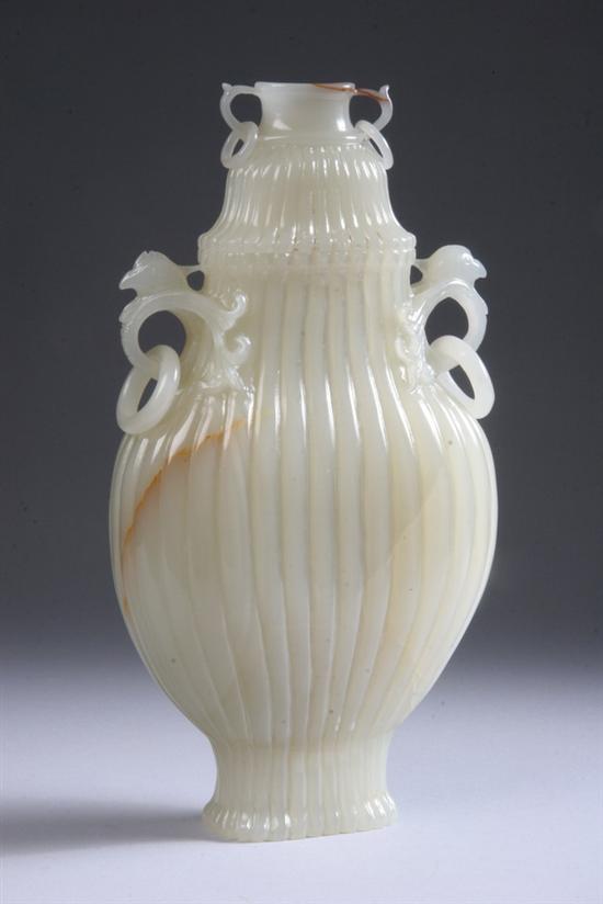 Appraisal: CHINESE CELADON JADE VASE AND COVER Flattened ovoid-form with ribbed