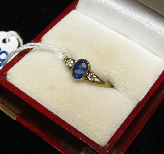 Appraisal: SAPPHIRE DIAMOND AND NINE KARAT GOLD RING centering an oval