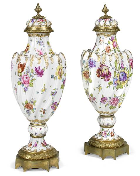 Appraisal: A pair of Continental gilt bronze mounted porcelain covered urns