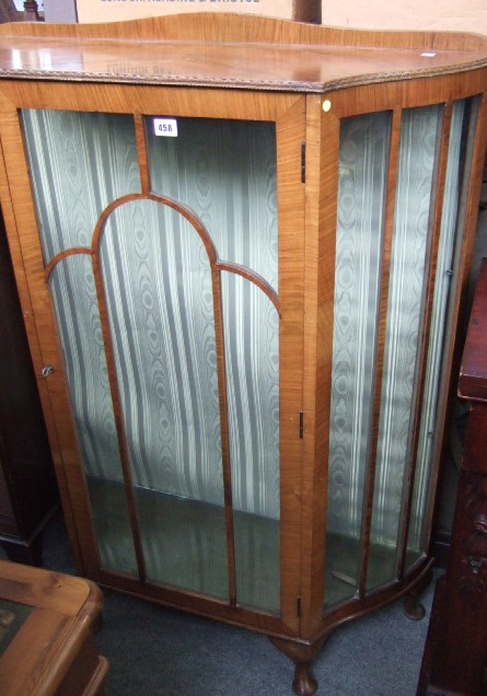 Appraisal: A 's walnut display cabinet with shaped glazed doors raised