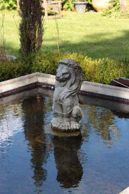 Appraisal: A RECONSTITUTED STONE FOUNTAIN in the form of a seated