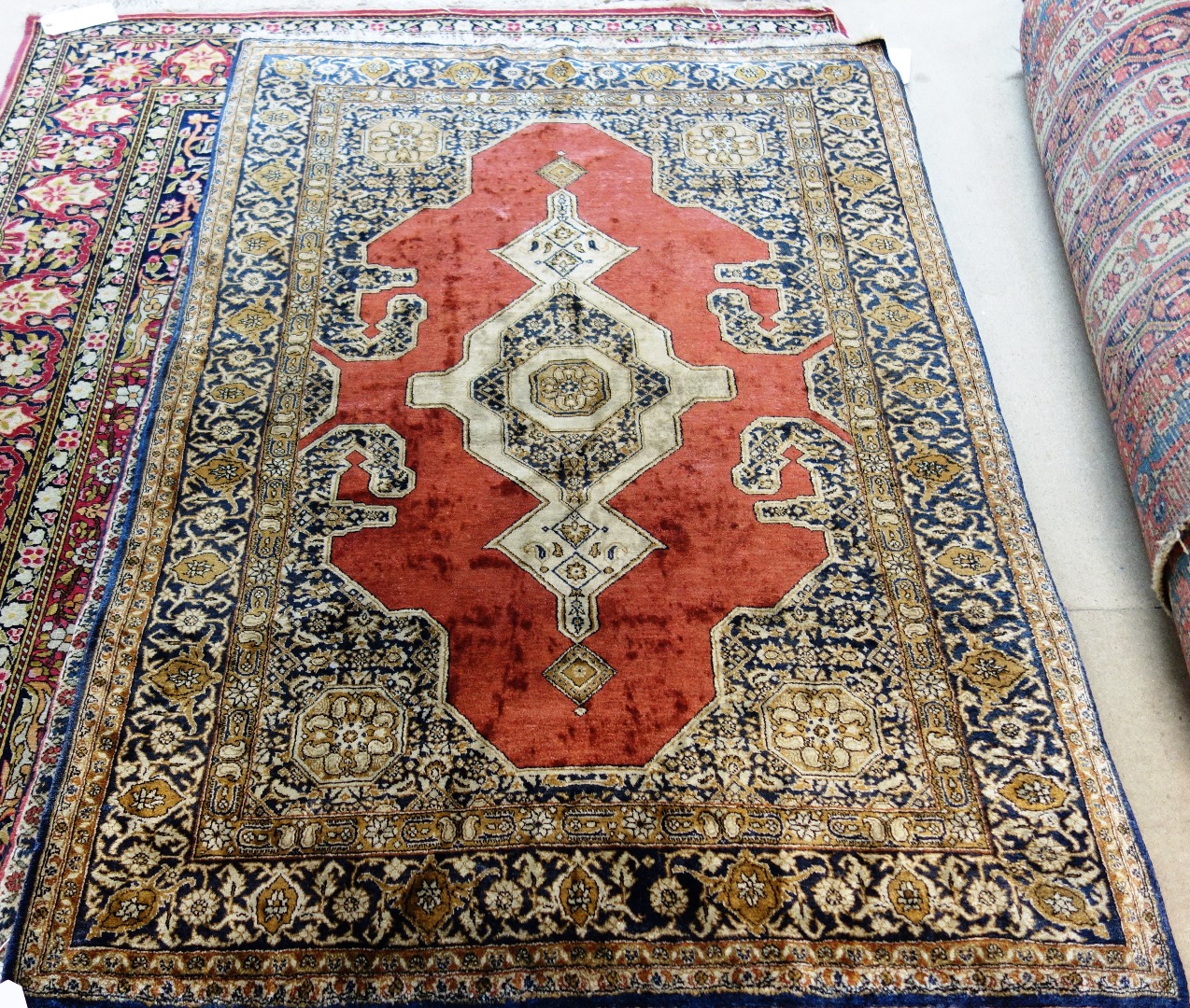 Appraisal: A Ghom silk rug Persian the plain madder field with