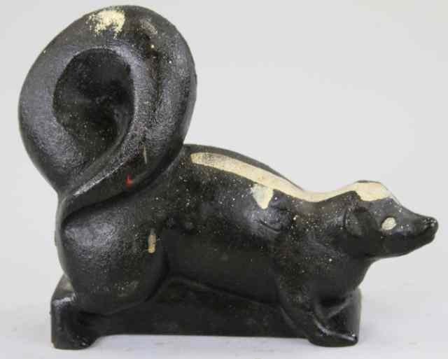 Appraisal: SKUNK DOORSTOP Heavily cast hollow piece portrays ''Little Stinker'' raised