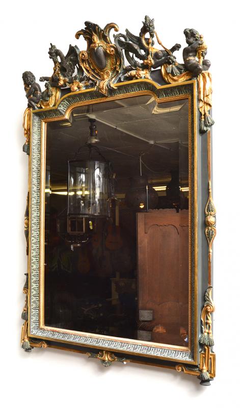 Appraisal: A FRENCH EMPIRE STYLE WALL MIRROR the bevelled rectangular plate