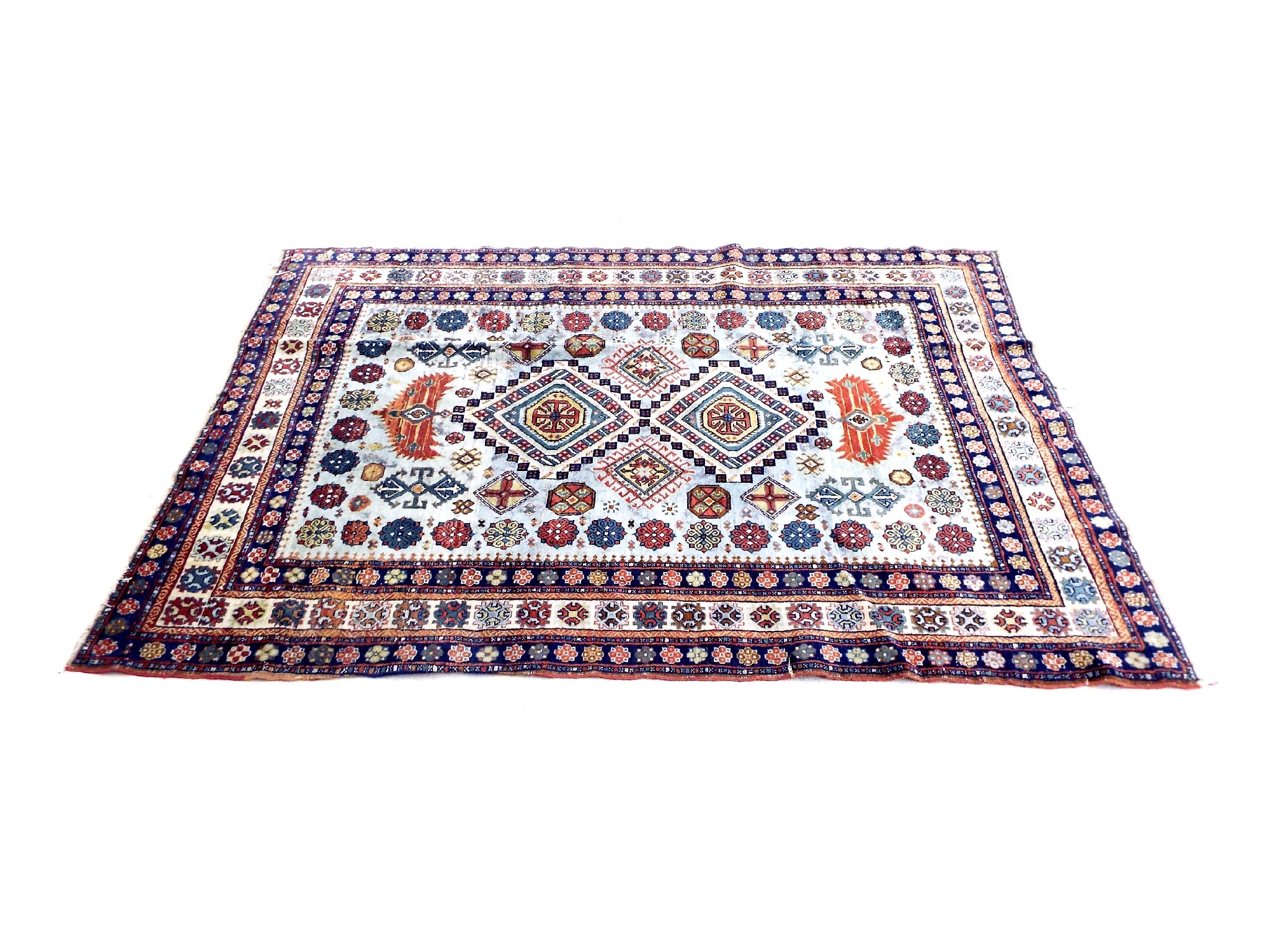 Appraisal: Antique Caucasian rug decorated with various coloured medallions upon a