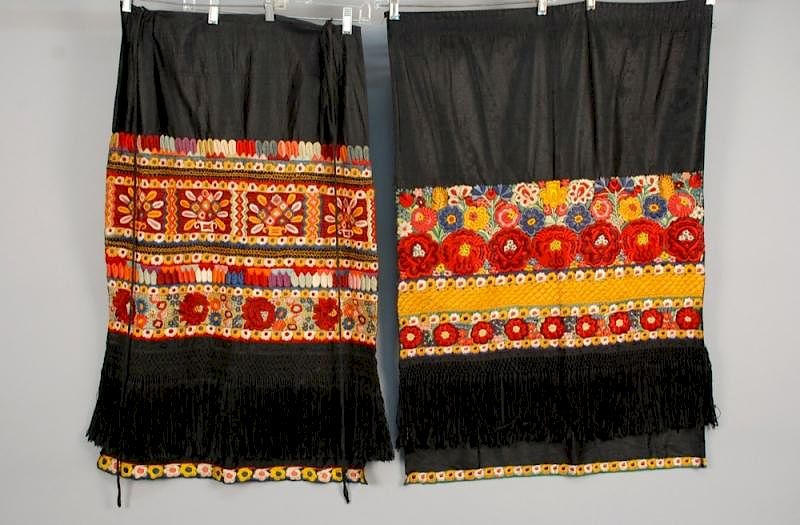 Appraisal: TWO ETHNIC POLYCHROME EMBROIDERED APRONS MID th C Probably eastern