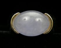 Appraisal: A Lavender Jade Ring Saddle set this rounded Jade stone