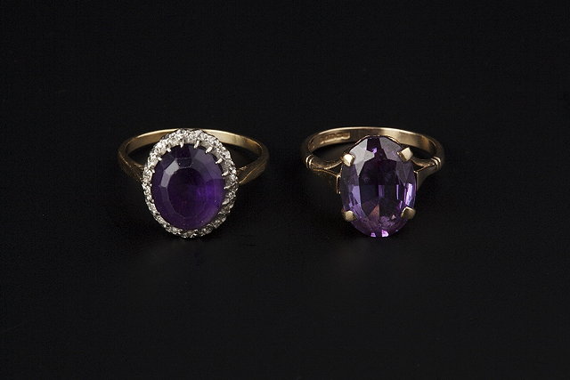 Appraisal: AN AMETHYST AND DIAMOND CLUSTER RING the oval mixed-cut amethyst