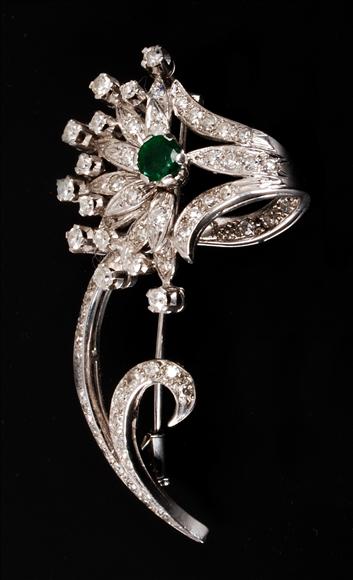 Appraisal: A emerald and diamond brooch designed as a stylized floral