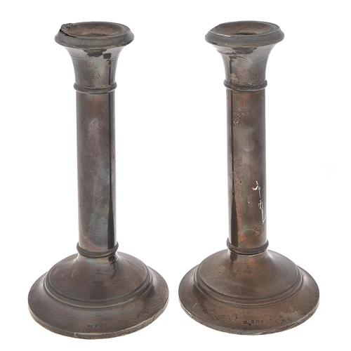 Appraisal: A pair of George V plain columnar silver candlesticks cm