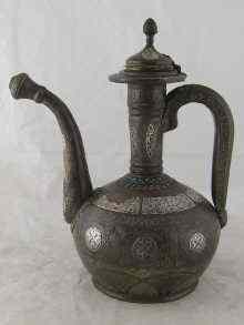 Appraisal: An Islamic coffee ewer of traditional form with white metal