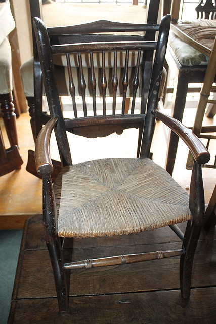 Appraisal: A TH CENTURY BEECHWOOD CHILD'S SPINDLE BACK CHAIR with rush