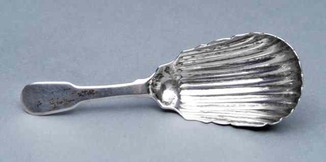 Appraisal: A GEORGE III IRISH SILVER CADDY SPOON with shell shaped