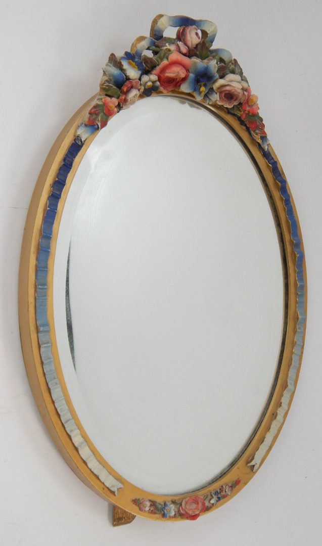 Appraisal: A Barbola style bevelled oval dressing table mirror decorated with