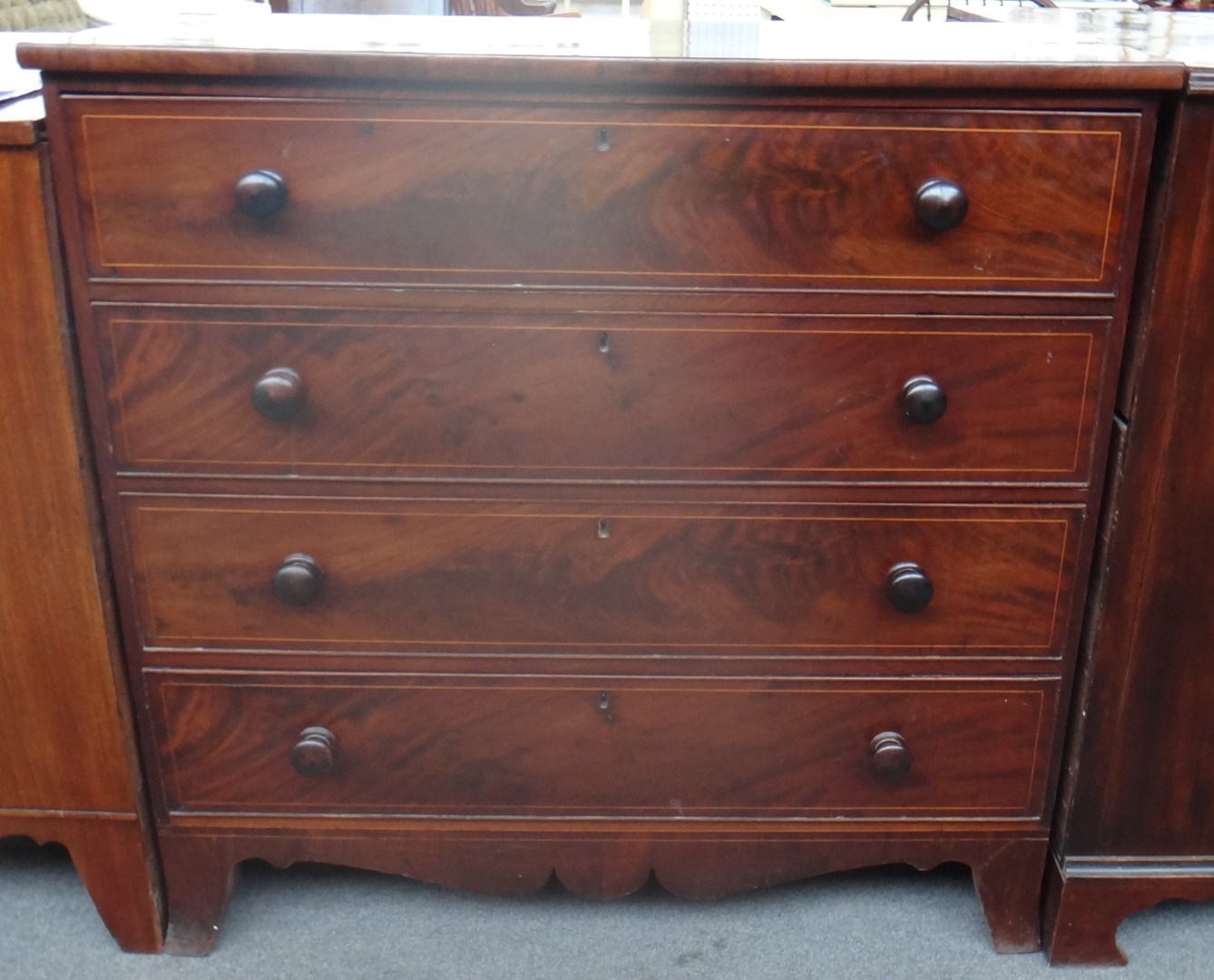 Appraisal: A George III inlaid chest of three long graduated drawers