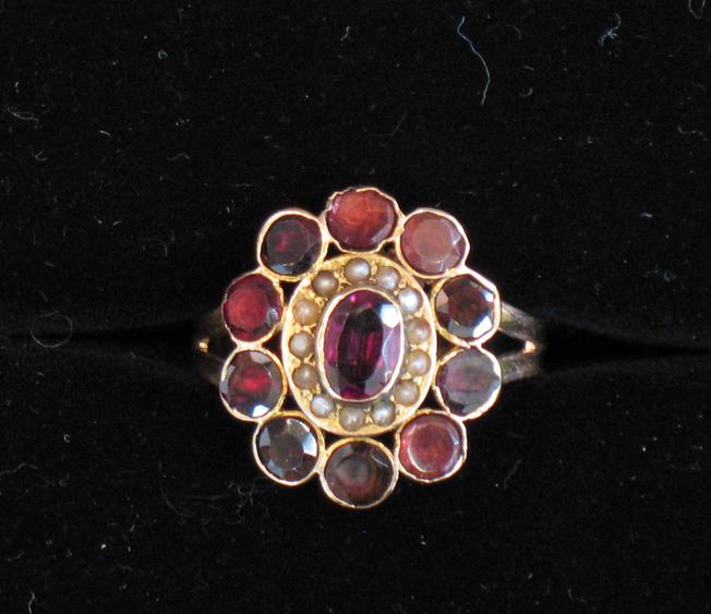 Appraisal: A VICTORIAN GARNET DRESS RING the central oval cushion-cut almandine