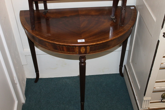 Appraisal: A REPRODUCTION DEMI-LUNE SIDE TABLE on fluted supports