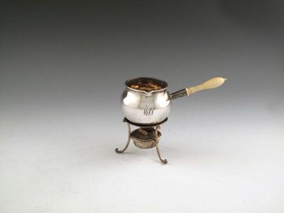 Appraisal: A late-Victorian silver small brandy pan and warming stand by