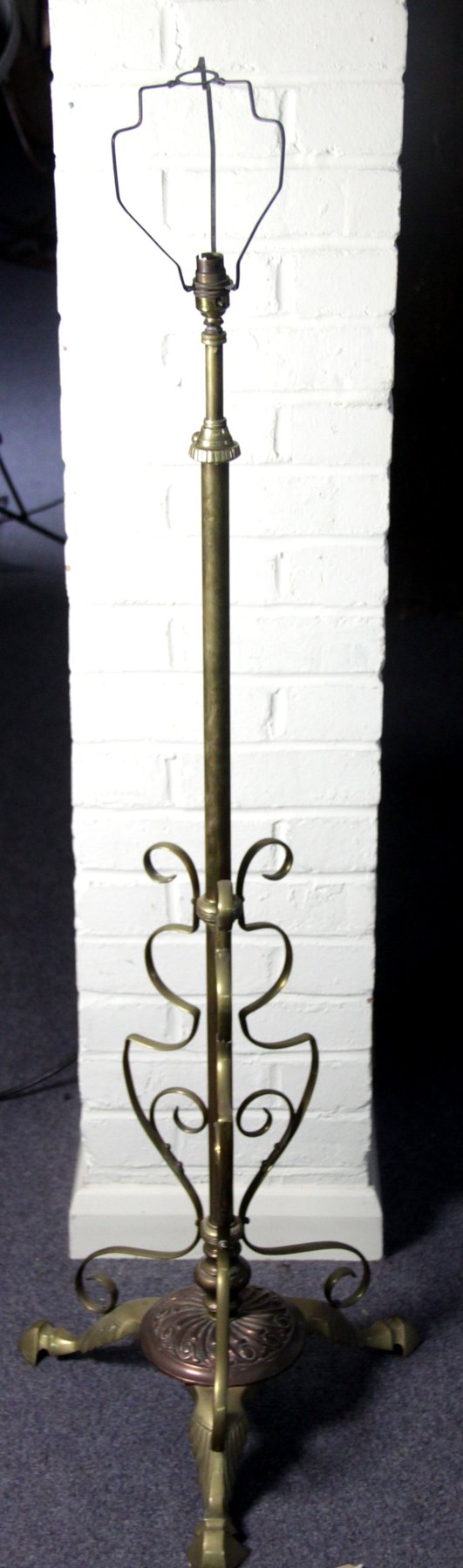 Appraisal: An adjustable brass standard lamp circa with tripod base cm