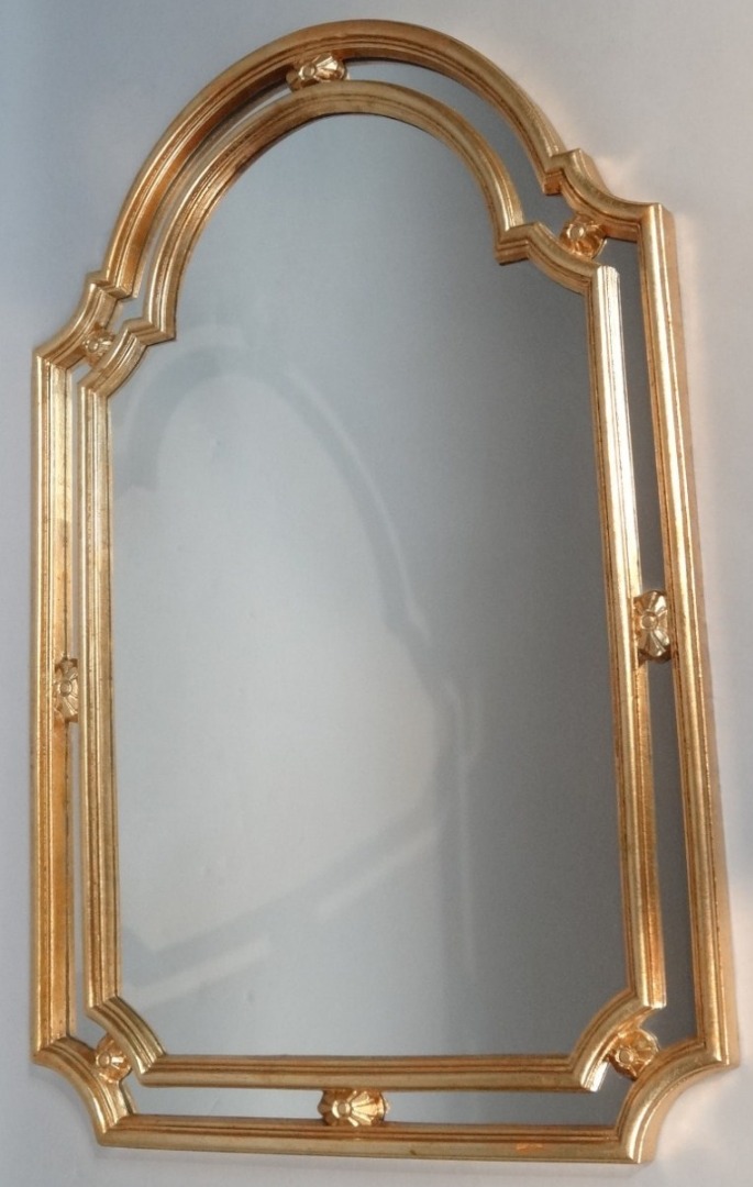 Appraisal: A thC gilt wood mirror with a shaped outline and