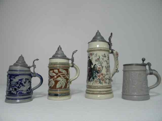 Appraisal: Lot of four German porcelain and stoneware beers steins Includes